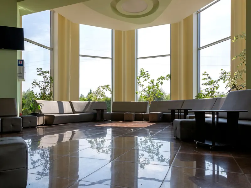Empty, clean lobby with polished floors and large windows